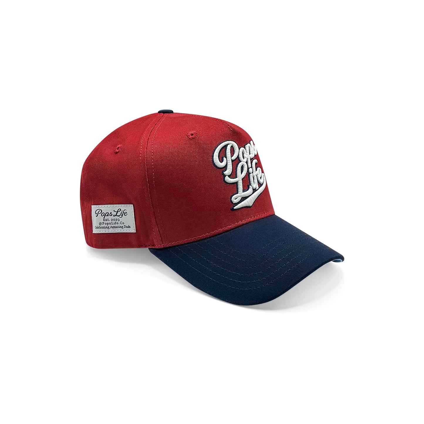 A side view of the Pops Life Maroon Blue Dad Hat showcasing the vibrant maroon crown, navy brim, and the embroidered Pops Life logo with a detailed patch on the side.