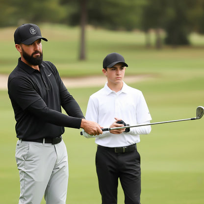 Man and young boy on a golf course with a golf club