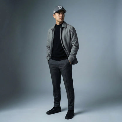 Man wearing a gray jacket, black shirt, gray pants, and black shoes with a Pops Life Gray and Black Dad Hat against a gray background