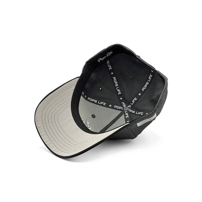 Inside view of Pops Life dad hat showing branded taping, stitched eyelets, and structured crown support.
